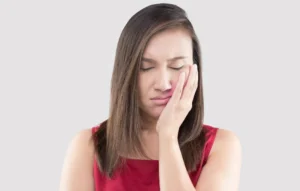 suffering-from-a-toothache-asian-woman-wearing-a-red-shirt-suffering-from-a-toothache-while-standing